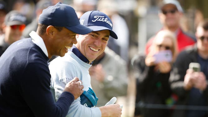 Justin Thomas laughs after Tiger Woods hands him a tampon, the proper response to a funny joke.