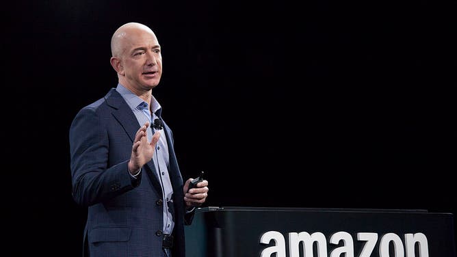 Jeff Bezos speaking at an event. Bezos and Jay-Z are teaming up to bid on the Washington Commanders.