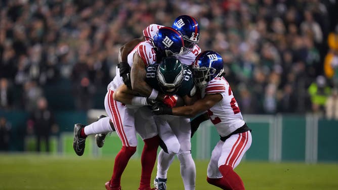 Eagles TE Dallas Goedert drags New York Giants defenders during the NFC Divisional Round at Lincoln Financial Field in Philadelphia.
