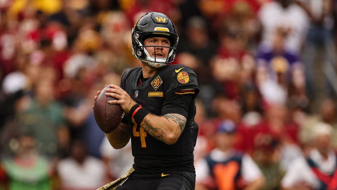 Washington Commanders QB Taylor Heinicke looks to pass against the Minnesota Vikings during the second half of the game at FedExField in Landover, Maryland.