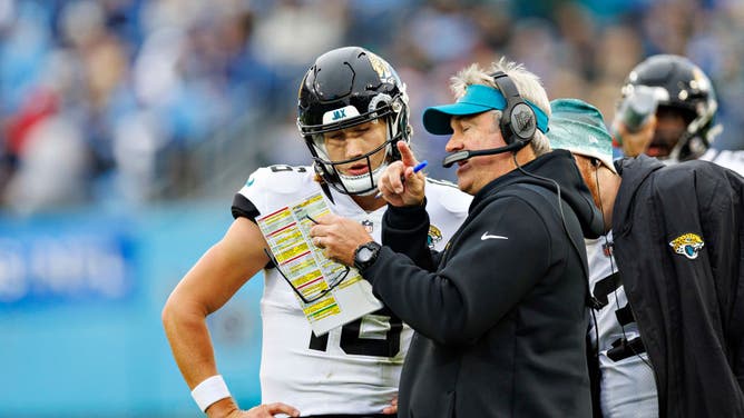 Jacksonville Jaguars coach Doug Pederson talks with QB Trevor Lawrence during a game vs. the Tennessee Titans at Nissan Stadium in Nashville, Tennessee.