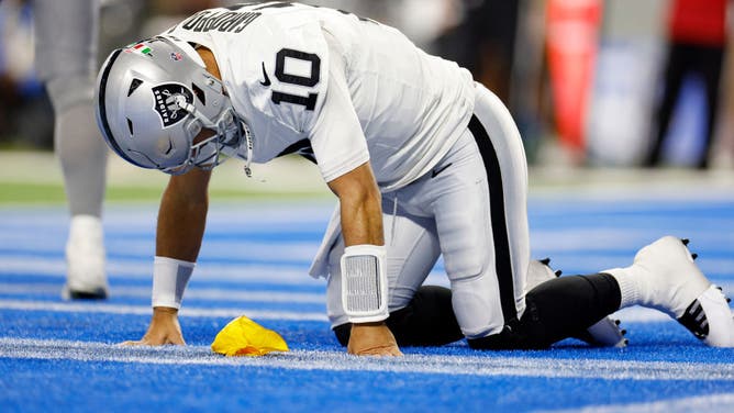 Jimmy Garoppolo of the Las Vegas Raiders stays down after a hit against the Detroit Lions.