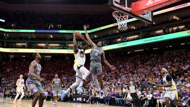 Warriors PF Draymond Green goes to the hoop with Kings SG Malik Monk contesting during Game 5 of the NBA Western Conference First Round Playoffs at Golden 1 Center in Sacramento, California.
