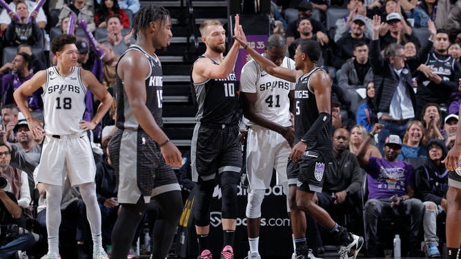 Kings big Domantas Sabonis and PG DeAaron Fox high-five during the game against the Spurs at Golden 1 Center in Sacramento, California.