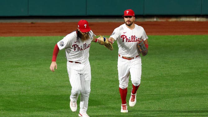 Phillies OFs Brandon Marsh and Kyle Schwarber fist bump vs. the Houston Astros in the 2022 World Series at Citizens Bank Park in Philadelphia.