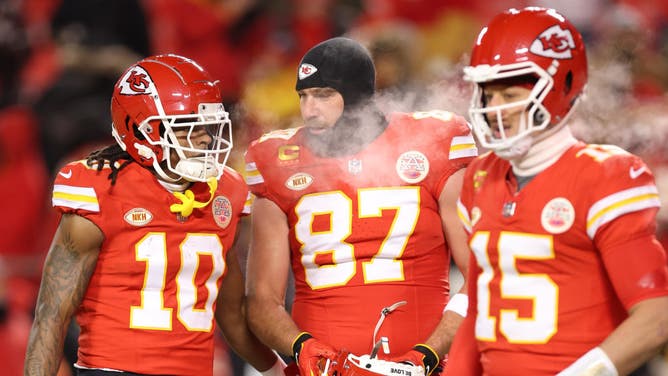Chiefs RB Isiah Pacheco, TE Travis Kelce, and QB Patrick Mahomes stand on the field before the AFC Wild Card Playoffs vs. the Miami Dolphins in Kansas City.