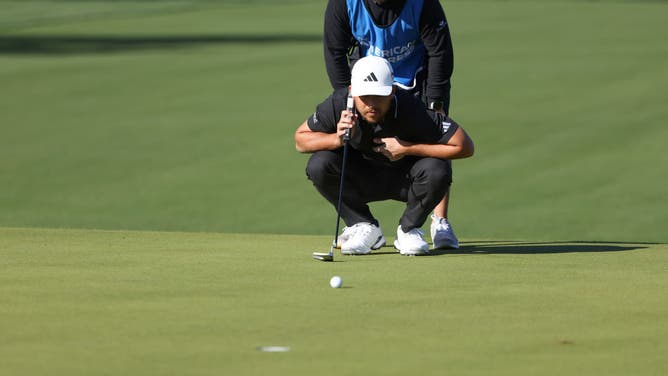 Xander Schauffele lines up a putt during the 1st round of The American Express at PGA West La Quinta Country Club in La Quinta, California.