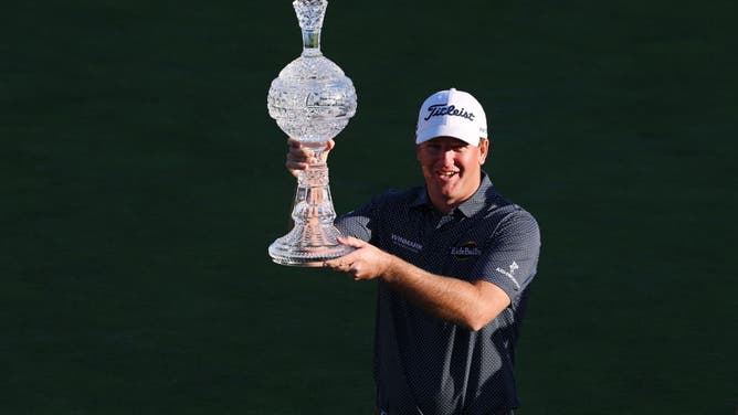 Tom Hoge celebrates with the trophy after winning the AT&T Pebble Beach Pro-Am at Pebble Beach Golf Links in California.