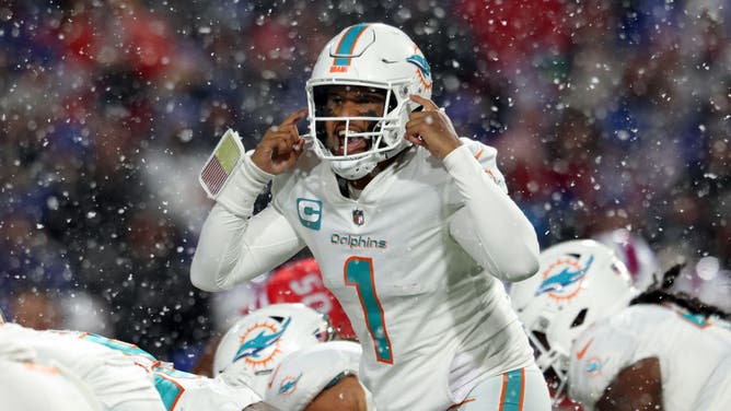 Miami Dolphins QB Tua Tagovailoa signals at the line of scrimmage against the Buffalo Bills at Highmark Stadium in Orchard Park, New York.