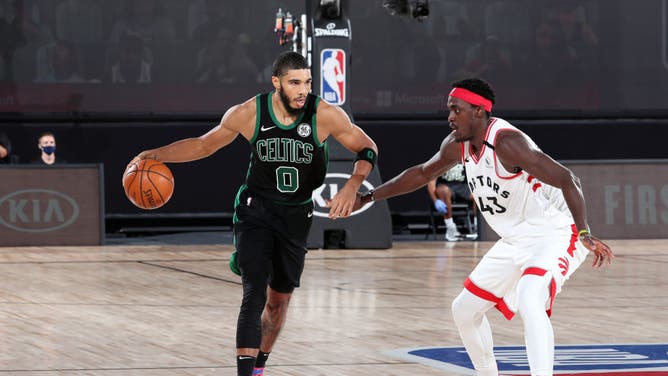 Boston Celtics SF Jayson Tatum brings the ball up the courth while Toronto Raptors F Pascal Siakam plays defense during the Eastern Conference Semifinals at The AdventHealth Arena at ESPN Wide World Of Sports Complex in Orlando, Florida.