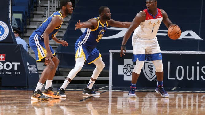 Golden State Warriors forwards Draymond Green and Andrew Wiggins play defense on New Orleans Pelicans PF Zion Williamson at the Smoothie King Center in New Orleans.