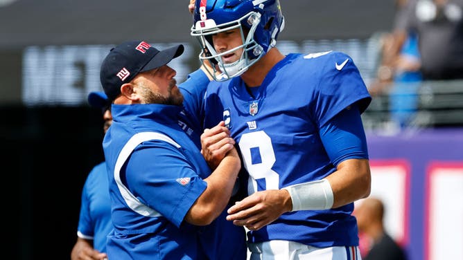 New York Giants coach Brian Daboll talks with QB Daniel Jones before a game against the Carolina Panthers at MetLife Stadium in East Rutherford, New Jersey.