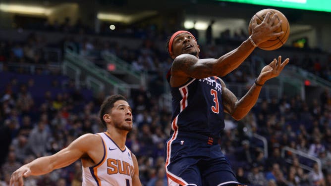 Former Wizards SG Bradley Beal puts up a layup vs. Suns SG Devin Booker at Talking Stick Resort Arena in Phoenix, Arizona.