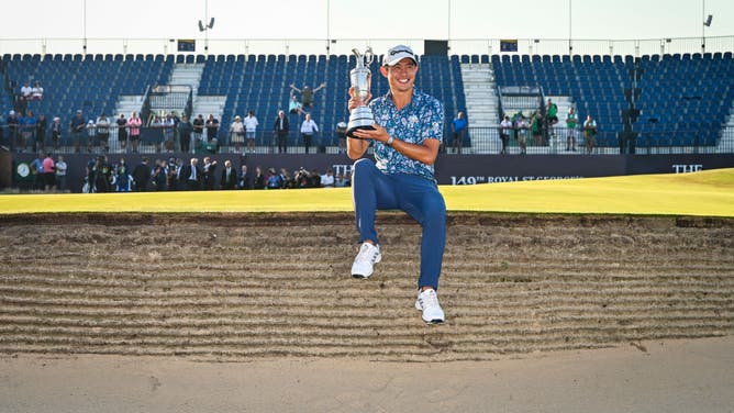 Collin Morikawa smiles with the Claret Jug trophy following his 149th The Open Championship victory at Royal St. Georges Golf Club in Sandwich, England.