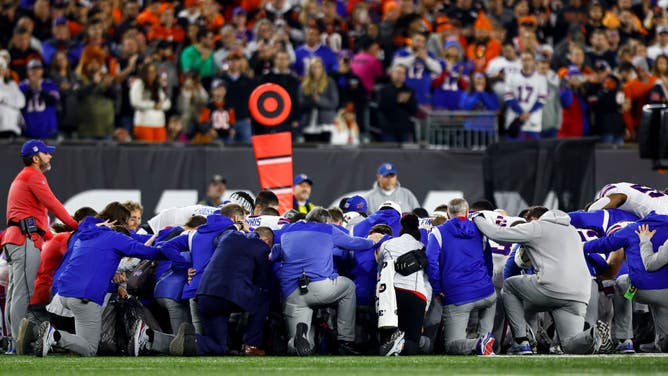 Buffalo Bills players and staff kneel together in solidarity after Damar Hamlin sustained an injury against the Cincinnati Bengals. The defense took the field after the team meeting and ESPN reported the teams had five minutes to get ready for the resumption of play.