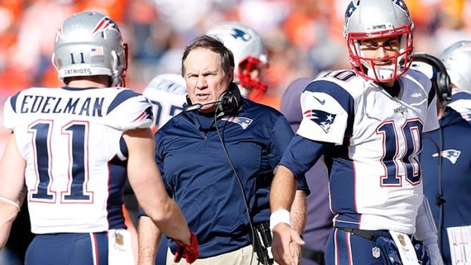 Head coach Bill Belichick of the New England Patriots speaks to Julian Edelman #11 in the first half against the Denver Broncos in the AFC Championship game at Sports Authority Field at Mile High on January 24, 2016 in Denver, Colorado.