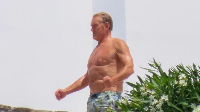 EXCLUSIVE: Dolph Lundgren goes shirtless during romantic Greek vacation with much younger fiancee Emma Krokdal amid his lung cancer battle.