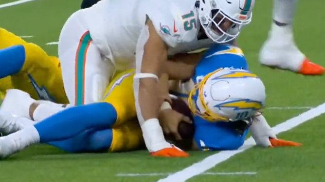 Dolphins DE Jaelen Phillips appears to brace himself but still gets called for roughing the passer on Sunday Night Football against the Chargers