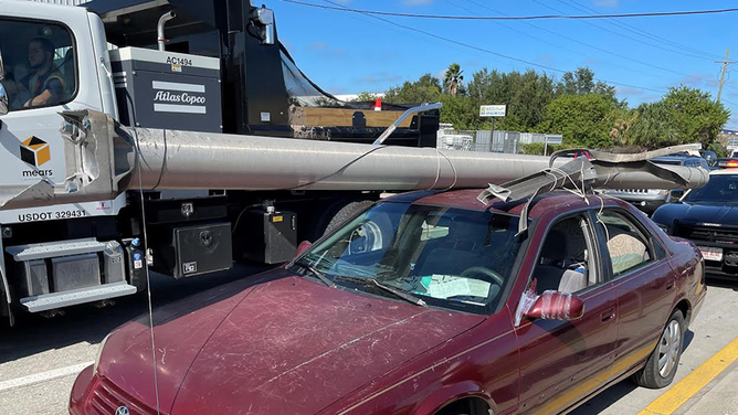 Florida Man with power pole on his car - 2