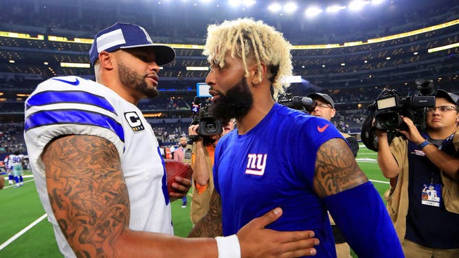 Cowboys QB and former Giants WR Odell Beckham embrace on the field after a game between the teams.