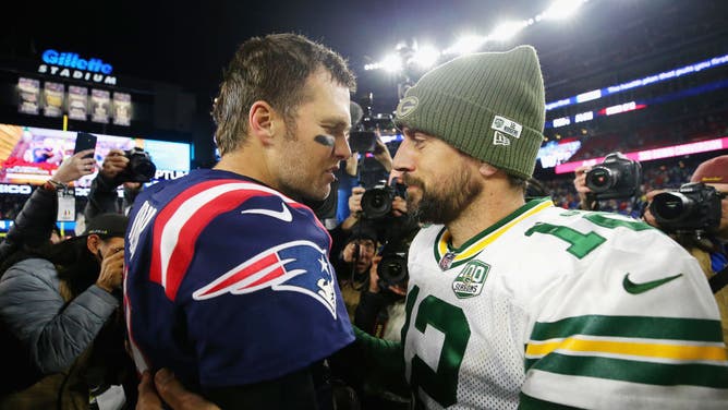 Tom Brady of the New England Patriots talks with Aaron Rodgers of the Green Bay Packers after a game between the two.