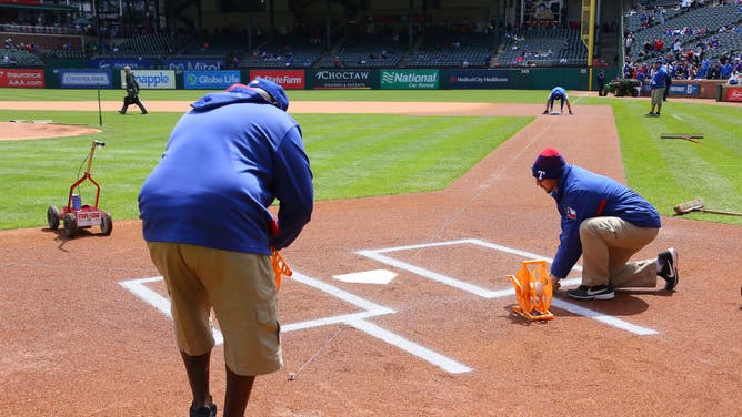 Texas Rangers grounds crew prepare the field for an MLB game against the Chicago Cubs at Globe Life Park in Arlington.
