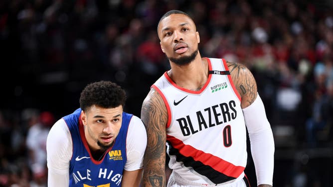 Denver Nuggets PG Jamal Murray and Portland Trail Blazers PG Damian Lillard look on during Game 6 of the Western Conference Semifinals of the 2019 NBA Playoffs at the Moda Center in Portland, Oregon.