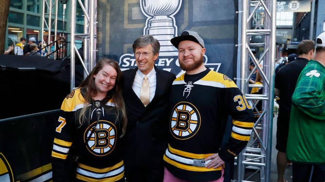 Bruins' TV play by play announcer Jack Edwards poses with Boston fans.