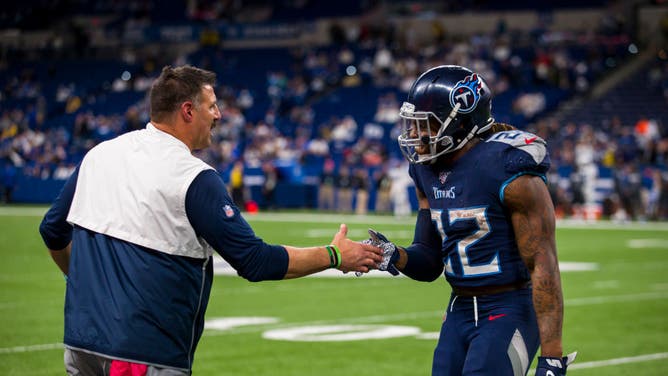Head coach Mike Vrabel high fives Derrick Henry of the Tennessee Titans during the fourth quarter against the Indianapolis Colts at Lucas Oil Stadium.