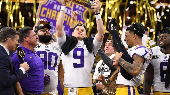 LSU Tigers QB Joe Burrow holds up the trophy after defeating the Clemson Tigers during the College Football Playoff National Championship at the Mercedes-Benz Superdome in New Orleans.