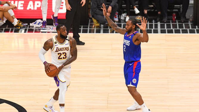 Lakers' LeBron James by Clippers' Kawhi Leonard at the then-STAPLES Center in Los Angeles.