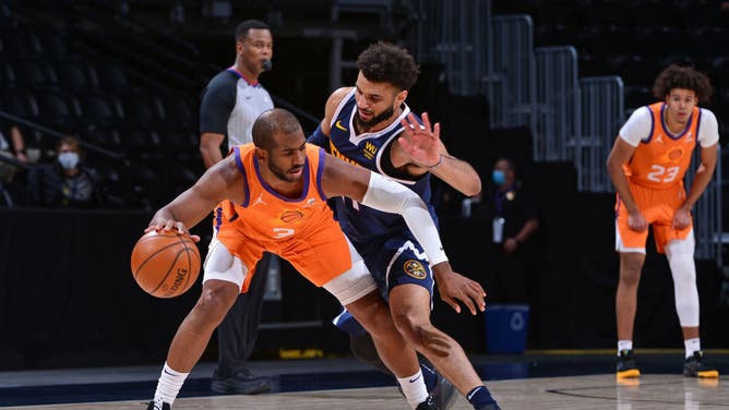 Nuggets PG Jamal Murray defends Suns PG CP3 at the Ball Arena in Denver, Colorado.