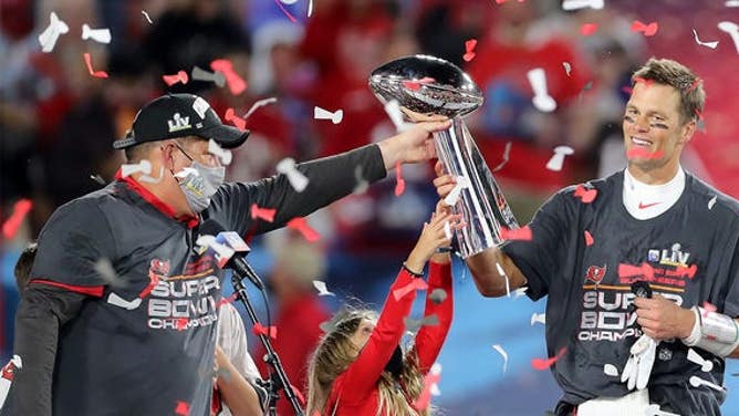 Super Bowl MVP Tom Brady of the Buccaneers accepts the Lombardi Trophy from general manager Jason Licht after Super Bowl LV between the Kansas City Chiefs and the Tampa Bay Buccaneers Feb. 7, 2021, at Raymond James Stadium, in Tampa, Fla. 