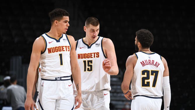 Denver Nuggets SF Michael Porter Jr. C Nikola Jokic and PG Jamal Murray strategize during the game against the Indiana Pacers at the Ball Arena in Denver.