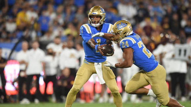 PASADENA, CA - OCTOBER 02: UCLA Bruins QB Dorian Thompson-Robinson hands off to RB Zach Charbonnet for a run against the Arizona State Sun Devils at the Rose Bowl in Pasadena, California.