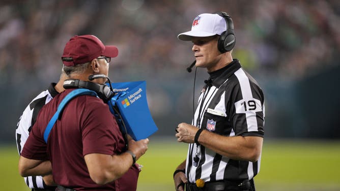 NFL referee Clay Martin looks at instant replay during a game.