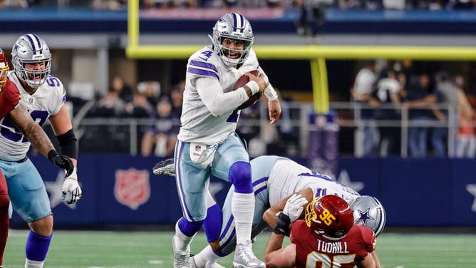 Dallas Cowboys QB Dak Prescott gets flushed out of the pocket during the game against the Washington Football Team at AT&T Stadium in Arlington, Texas.