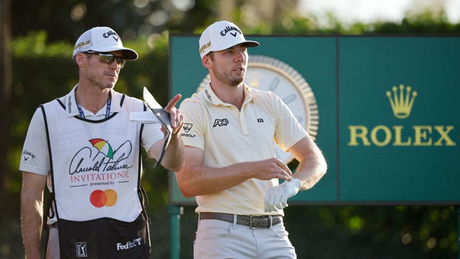 Sam Burns talks with caddie Travis Perkins at the 17th tee during the 1st round of the Arnold Palmer Invitational at Bay Hill Golf Course in Orlando, Florida.