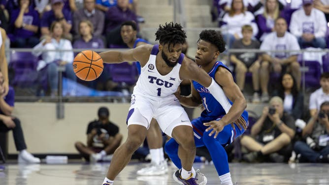 TCU Horned Frogs G Mike Miles Jr. backs down Kansas Jayhawks G Joseph Yesufu at Ed & Rae Schollmaier Arena in Fort Worth, Texas.