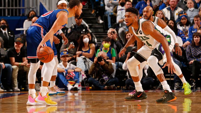 Milwaukee Bucks' Giannis Antetokounmpo plays defense on Golden State Warriors' Stephen Curry at Chase Center in San Francisco.