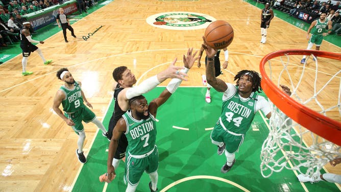 Boston Celtics C Robert Williams and SF Jaylen Brown go for a rebound against the Milwaukee Bucks during the 2022 NBA Playoffs Eastern Conference Semifinals at the TD Garden in Boston.