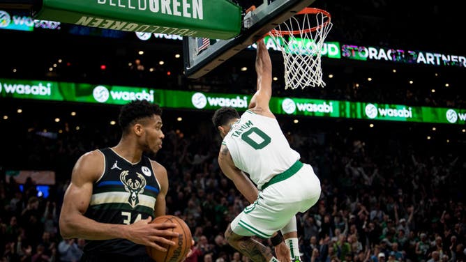 Boston Celtics SF Jayson Tatum hangs on the rim after a dunk during the Eastern Conference Semifinals against the Milwaukee Bucks at TD Garden in Boston.