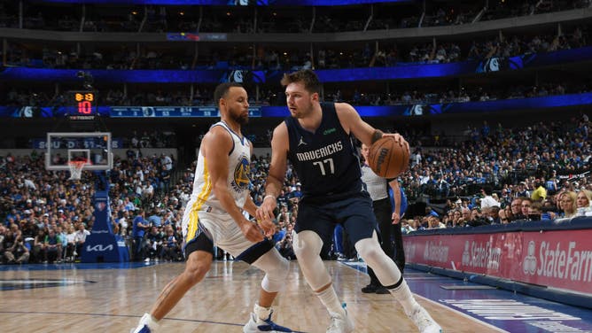 Dallas Mavericks All-Star Luka Doncic backs down Golden State Warriors PG Steph Curry during the 2022 NBA Playoffs Western Conference Finals at the American Airlines Center in Dallas.