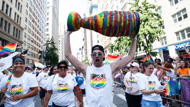 People participate in the NHL March during the NYC Pride Parade for members of the LGBTQ community.