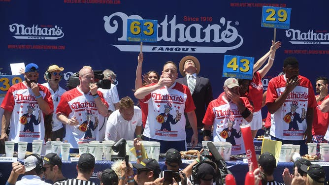 Competitive eaters Nick Wehry, Joey Chestnut and Geoffrey Esper participate in the 2022 Nathan's Famous International Hot Dog Eating Contest.