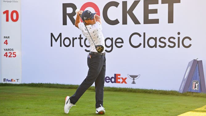 Rickie Fowler tees off on the 10th hole during the 1st round of the 2022 Rocket Mortgage Classic at Detroit Golf Club in Michigan.