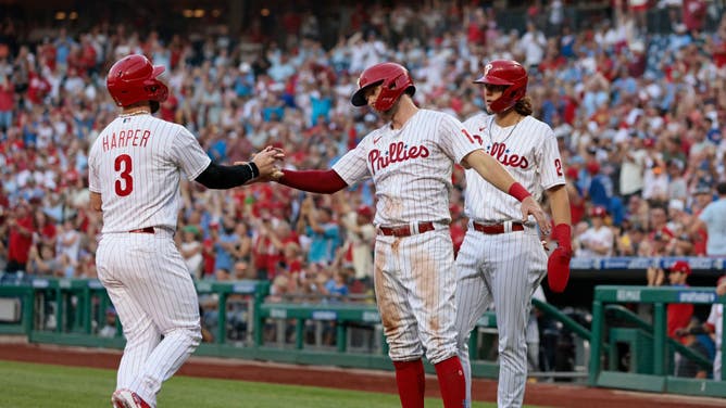 Harper high-fives Hoskins after scoring on a 3-run double at Citizens Bank Park in Philadelphia.
