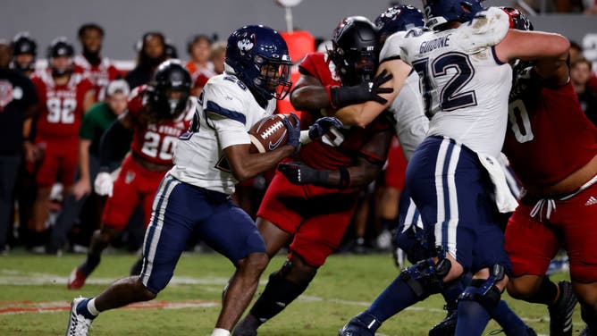 UConn RB Devontae Houston carries with the ball vs. NC State at Carter-Finley Stadium in Raleigh, North Carolina.