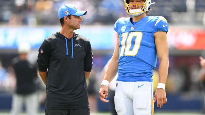 Chargers coach Brandon Staley talks to QB Justin Herbert before an NFL regular-season game with the Jacksonville Jaguars at SoFi Stadium in Los Angeles.