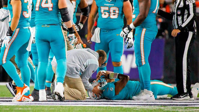 Miami Dolphins quarterback Tua Tagovailoa is attended by medical staff after being sacked by Cincinnati Bengals defensive tackle Josh Tupou.